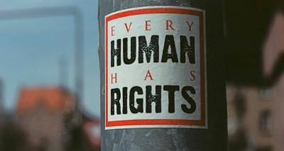 Urban street art sticker on metal pole says "Every Human Has Rights"