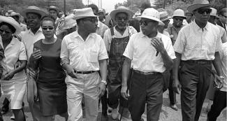 Coretta Scott King, Martin Luther King Jr., James Meredith, and Floyd McKissick lead march.