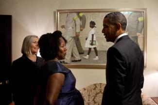 Ruby Bridges and President Obama look at Norman Rockwell painting featuring Bridges as a child going to school.