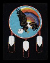 Beaded shield depicting a flying eagle and a rainbow with eagle feathers hanging below.