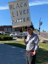 Ken Bedell holding a sign that says "Black Lives Matter"